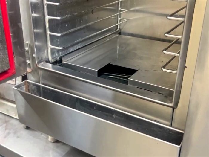 Inside the Cook and Hold Steamer: water shield over the reservoir and the drip tray below the door